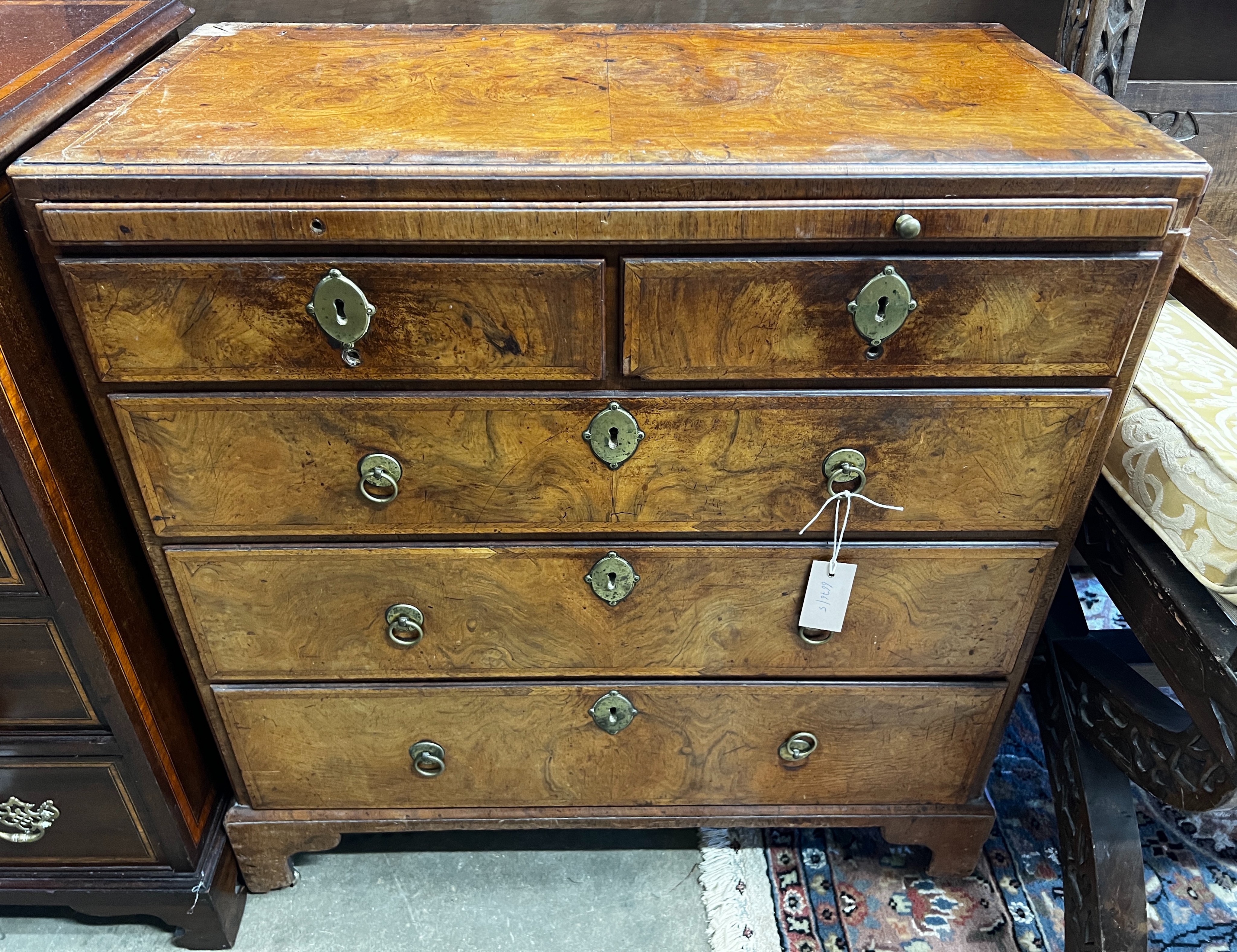 An 18th century feather banded figured walnut five drawer chest fitted slide, width 76cm, depth 40cm, height 87cm